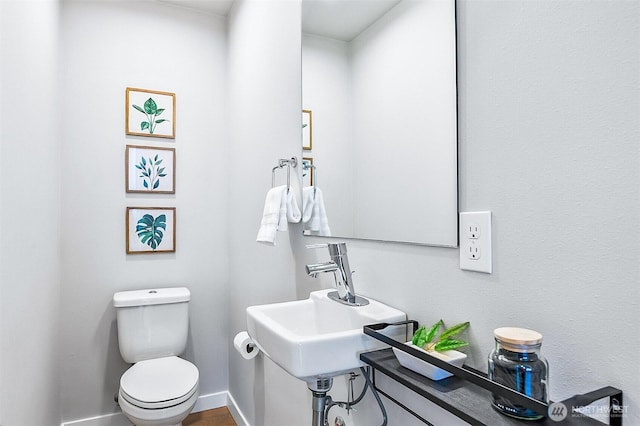 1709 NW 64th St, Seattle, WA 98107 - bathroom featuring toilet, a sink, and baseboards