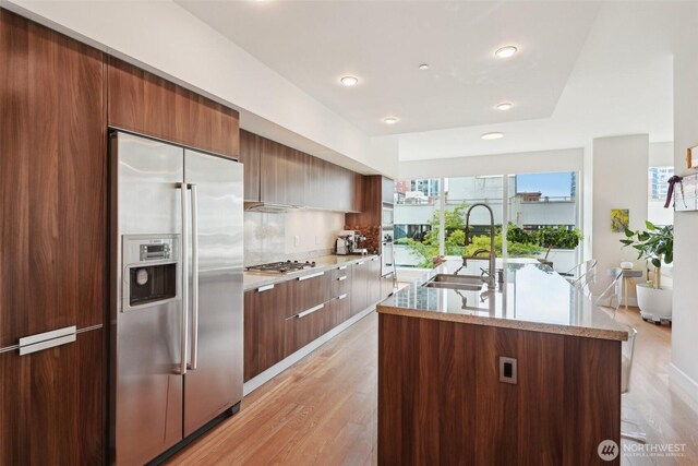 1920 4th Ave Unit 502, Seattle, WA 98101 - kitchen with appliances with stainless steel finishes, modern cabinets, a sink, recessed lighting, and light wood-type flooring