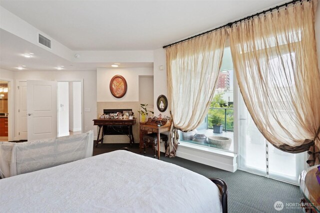 1920 4th Ave Unit 502, Seattle, WA 98101 - carpeted bedroom featuring access to outside, recessed lighting, and a fireplace