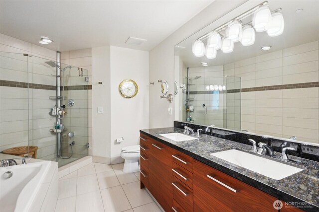 1920 4th Ave Unit 502, Seattle, WA 98101 - bathroom featuring a stall shower, tile patterned flooring, toilet, and double vanity