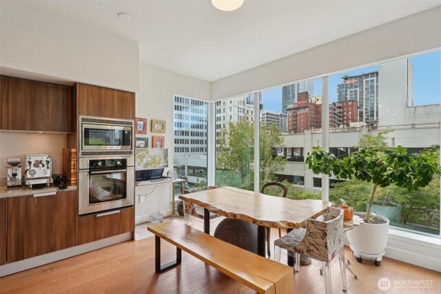 1920 4th Ave Unit 502, Seattle, WA 98101 - dining area with light wood-type flooring and a city view