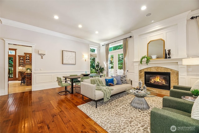 8380 SE 43rd St, Mercer Island, WA 98040 - living area featuring crown molding, a fireplace, wainscoting, and hardwood / wood-style flooring