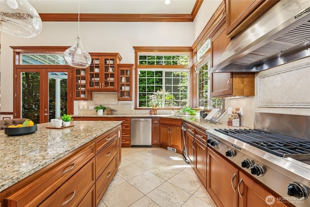 8380 SE 43rd St, Mercer Island, WA 98040 - kitchen with stainless steel appliances, tasteful backsplash, brown cabinets, ornamental molding, and range hood