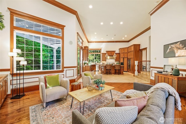 8380 SE 43rd St, Mercer Island, WA 98040 - living room featuring a high ceiling, a wainscoted wall, crown molding, light wood-style floors, and recessed lighting