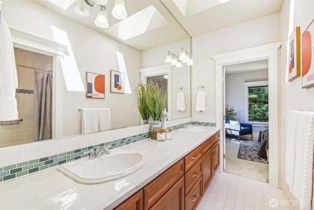 8380 SE 43rd St, Mercer Island, WA 98040 - ensuite bathroom featuring double vanity, connected bathroom, a skylight, and a sink