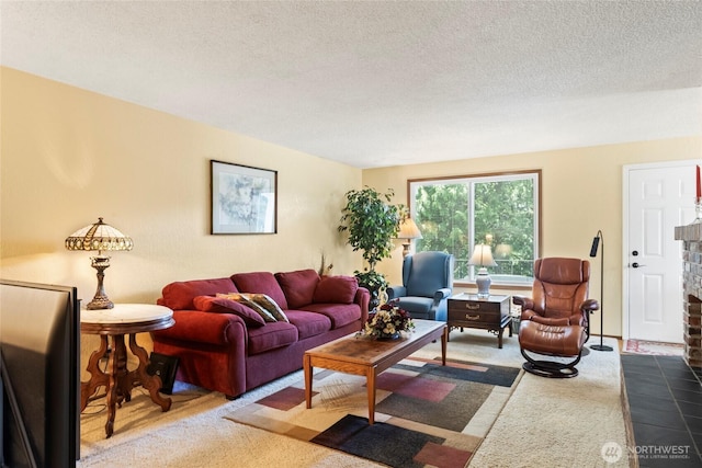 carpeted living area with a textured ceiling