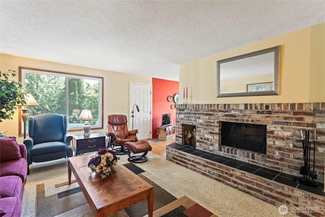 living room featuring a textured ceiling and a fireplace