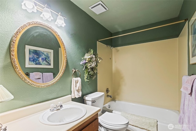bathroom with toilet, shower / bathtub combination, vanity, and a textured wall