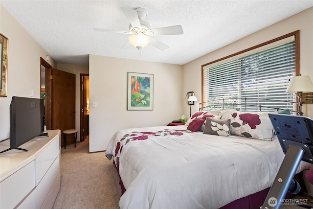 bedroom with light carpet, a textured ceiling, and ceiling fan