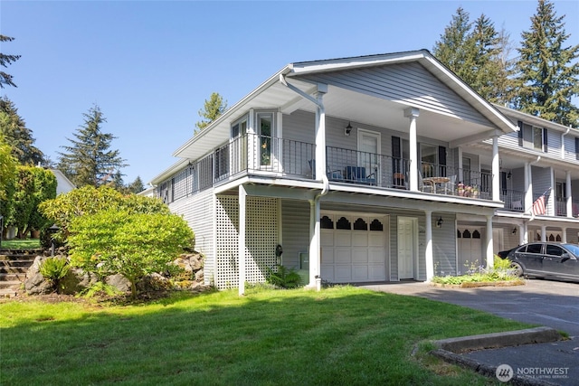 view of front facade featuring an attached garage, a balcony, and a front yard