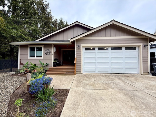 735 Dover Ct SE, Ocean Shores, WA 98569 - view of front of home featuring concrete driveway, a garage, fence, and board and batten siding