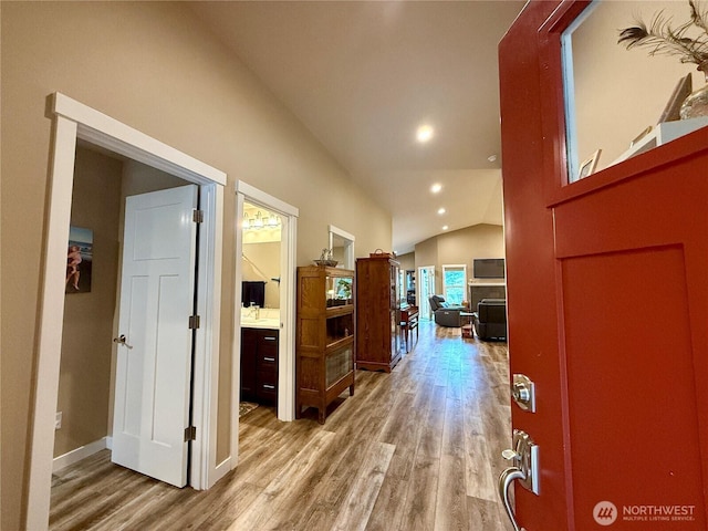 735 Dover Ct SE, Ocean Shores, WA 98569 - hallway with wood finished floors, lofted ceiling, recessed lighting, and baseboards