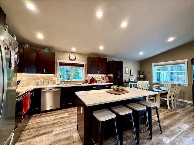 735 Dover Ct SE, Ocean Shores, WA 98569 - kitchen featuring appliances with stainless steel finishes, a sink, a kitchen breakfast bar, a center island, and recessed lighting