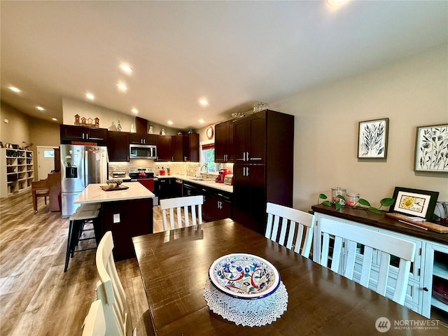 735 Dover Ct SE, Ocean Shores, WA 98569 - dining room with lofted ceiling, light wood-style flooring, and recessed lighting