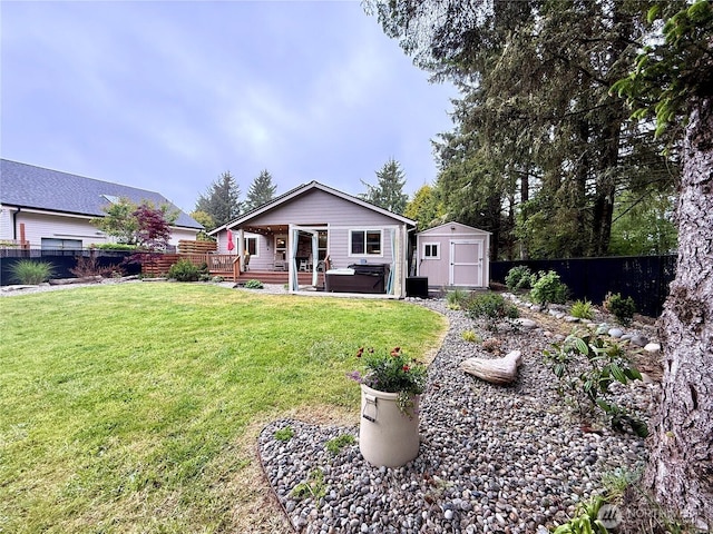 735 Dover Ct SE, Ocean Shores, WA 98569 - rear view of house with a hot tub, a shed, and an outbuilding