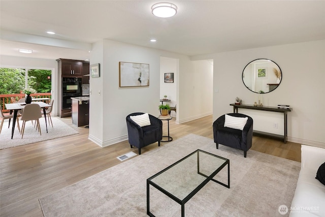 12635 Beacon Ave S, Seattle, WA 98178 - living area with light wood-style floors, recessed lighting, and baseboards