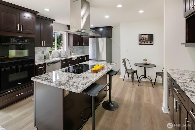 12635 Beacon Ave S, Seattle, WA 98178 - kitchen with black appliances, island range hood, a sink, light wood finished floors, and recessed lighting