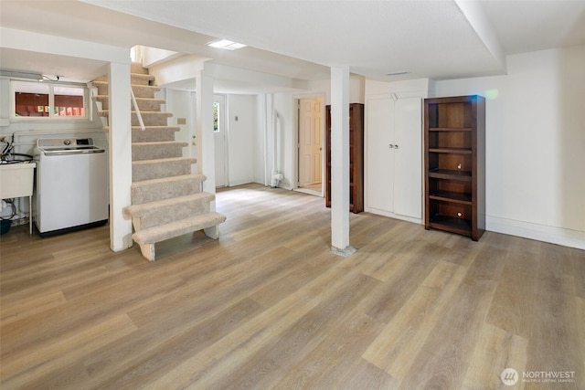 12635 Beacon Ave S, Seattle, WA 98178 - below grade area with washer / clothes dryer, light wood finished floors, stairway, and baseboards