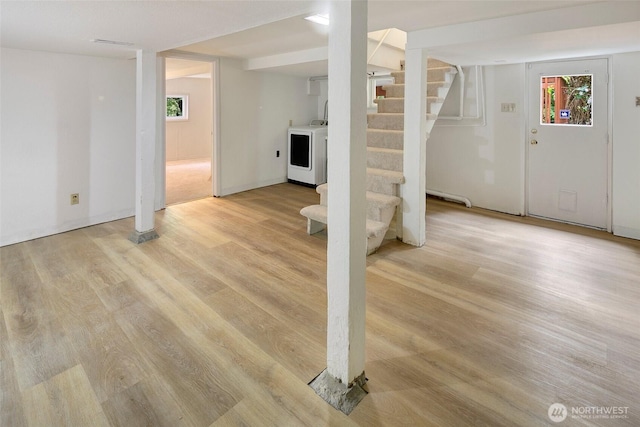 12635 Beacon Ave S, Seattle, WA 98178 - below grade area with washer / clothes dryer, stairway, healthy amount of natural light, and light wood-type flooring