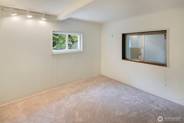 12635 Beacon Ave S, Seattle, WA 98178 - empty room featuring carpet flooring, beam ceiling, baseboards, and track lighting