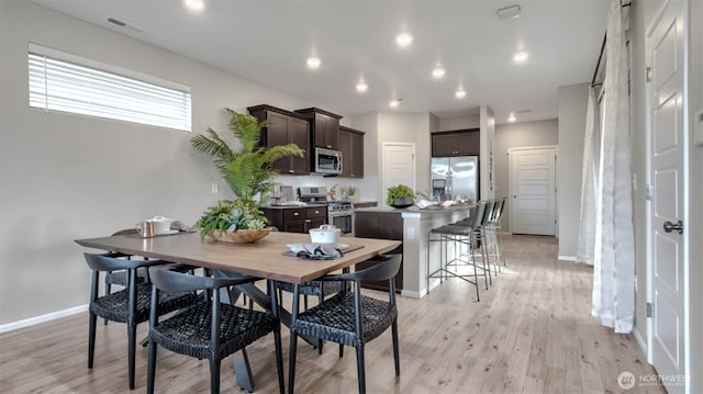 dining area featuring baseboards, recessed lighting, light wood-style floors, and visible vents