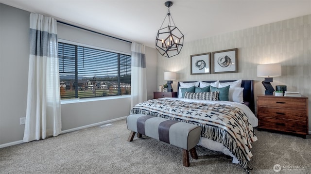 bedroom with baseboards, carpet flooring, and a chandelier