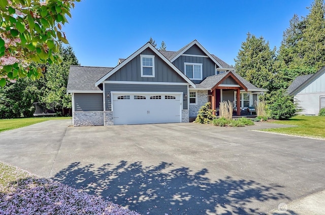 1827 Double Ditch Ct, Lynden, WA 98264 - craftsman house with stone siding, concrete driveway, board and batten siding, and roof with shingles