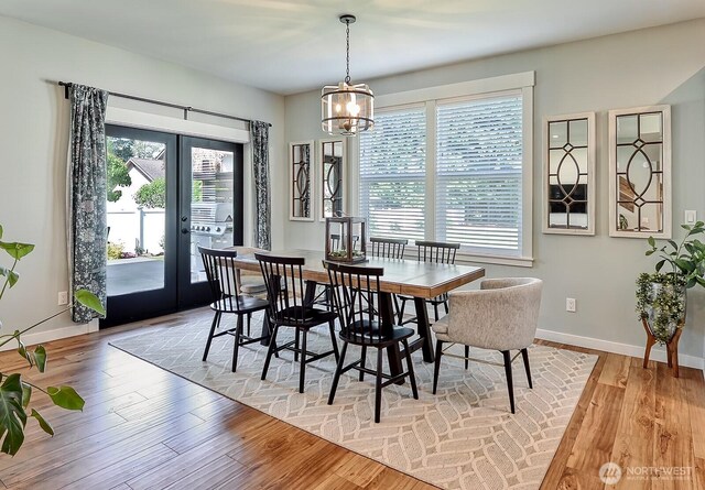 1827 Double Ditch Ct, Lynden, WA 98264 - dining area featuring healthy amount of natural light, french doors, a chandelier, and light wood-style flooring