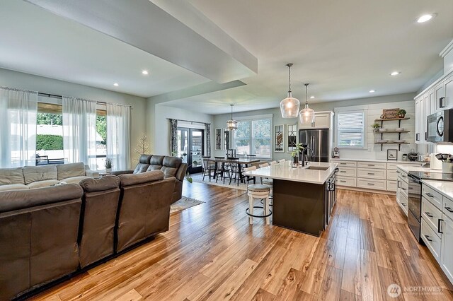 1827 Double Ditch Ct, Lynden, WA 98264 - kitchen with open floor plan, freestanding refrigerator, black electric range, light countertops, and recessed lighting