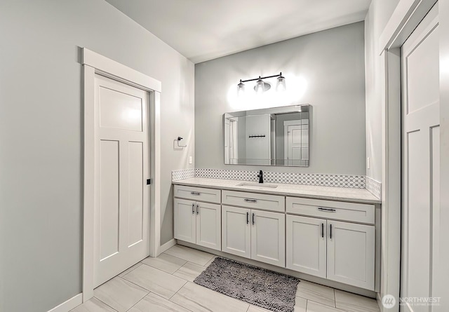 1827 Double Ditch Ct, Lynden, WA 98264 - bathroom featuring vanity, baseboards, and decorative backsplash