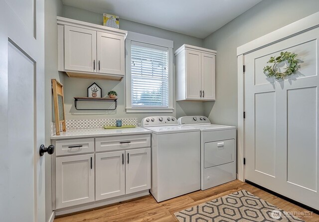 1827 Double Ditch Ct, Lynden, WA 98264 - washroom featuring cabinet space, washer and clothes dryer, and light wood-style floors