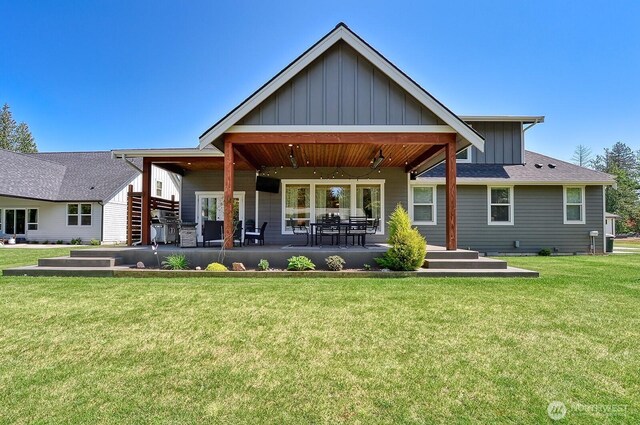 1827 Double Ditch Ct, Lynden, WA 98264 - back of property with board and batten siding, a yard, and a patio area