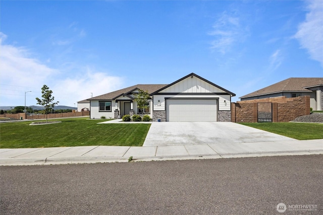3504 Kathren Ln, Pasco, WA 99301 - view of front of home with board and batten siding, a garage, concrete driveway, and stone siding