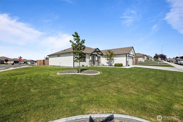3504 Kathren Ln, Pasco, WA 99301 - view of front of home featuring concrete driveway, a front yard, and an attached garage