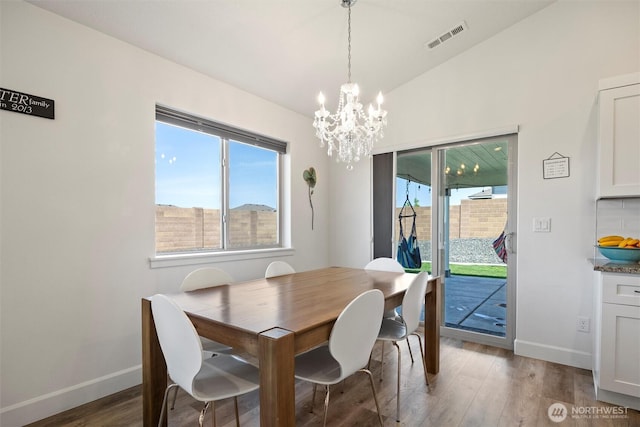 3504 Kathren Ln, Pasco, WA 99301 - dining room with a chandelier, wood finished floors, baseboards, and lofted ceiling