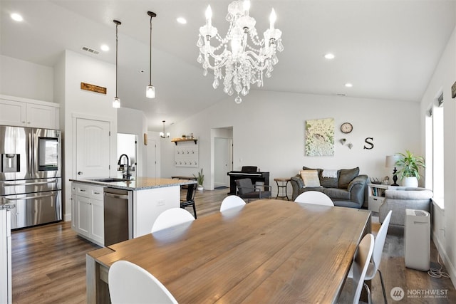 3504 Kathren Ln, Pasco, WA 99301 - dining space featuring lofted ceiling, a chandelier, wood finished floors, recessed lighting, and baseboards