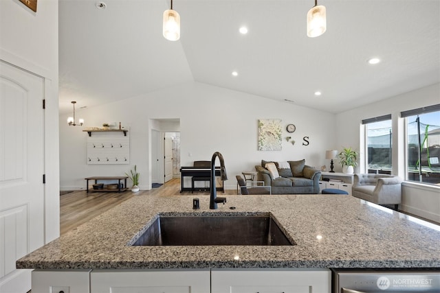 3504 Kathren Ln, Pasco, WA 99301 - kitchen with a sink, open floor plan, light stone countertops, light wood-style flooring, and lofted ceiling