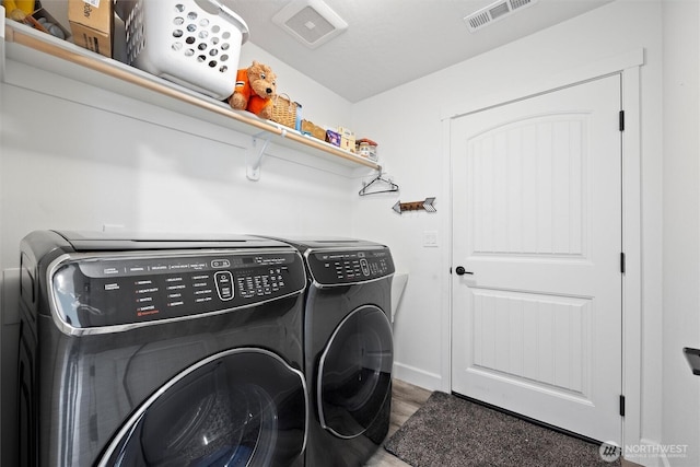 3504 Kathren Ln, Pasco, WA 99301 - laundry room with washing machine and clothes dryer and wood finished floors