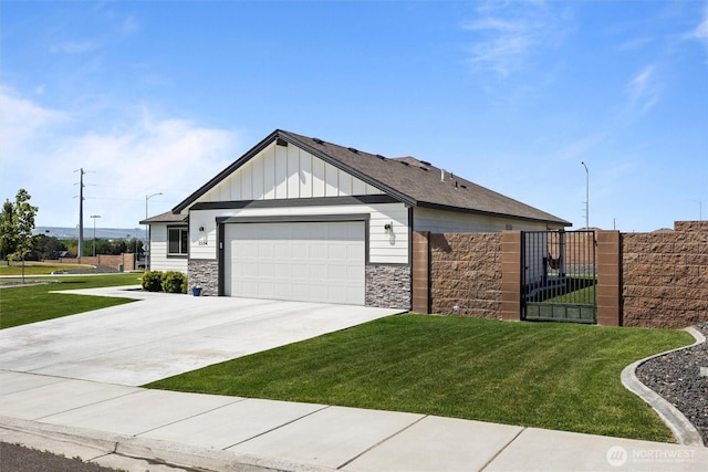 3504 Kathren Ln, Pasco, WA 99301 - view of front facade with stone siding, board and batten siding, an attached garage, and driveway