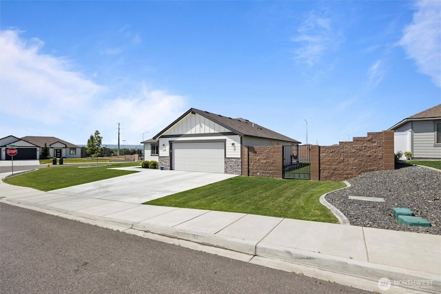 3504 Kathren Ln, Pasco, WA 99301 - single story home with stone siding, driveway, a gate, a garage, and board and batten siding