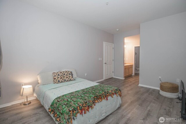 bedroom featuring wood finished floors and baseboards
