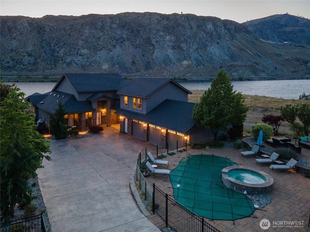 31 S Shore Dr, Orondo, WA 98843 - view of swimming pool with a fenced backyard, a water and mountain view, a patio area, and a pool with connected hot tub