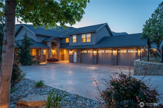 31 S Shore Dr, Orondo, WA 98843 - view of front of house featuring stone siding, driveway, stucco siding, an attached garage, and a porch