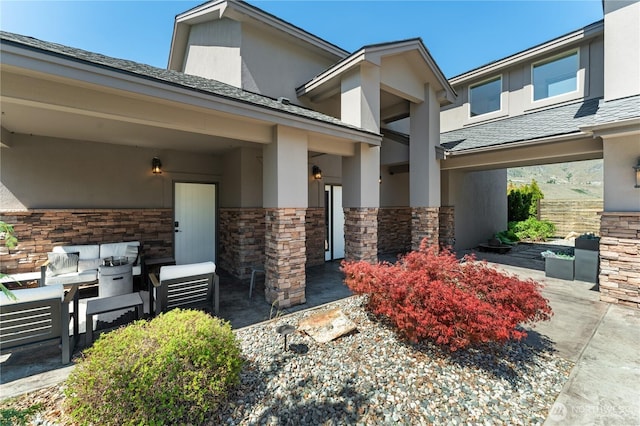 31 S Shore Dr, Orondo, WA 98843 - doorway to property featuring an outdoor hangout area, stone siding, stucco siding, and roof with shingles