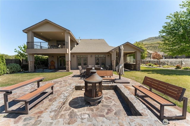 31 S Shore Dr, Orondo, WA 98843 - rear view of property featuring french doors, a balcony, a fire pit, a patio area, and stucco siding
