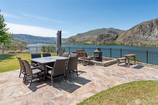 31 S Shore Dr, Orondo, WA 98843 - view of patio / terrace featuring fence, outdoor dining space, and a water and mountain view