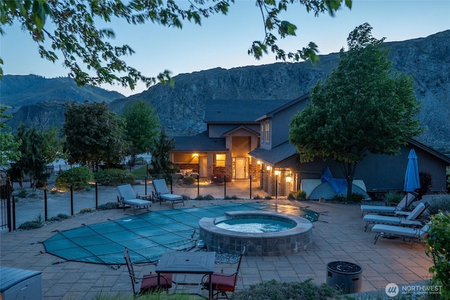 31 S Shore Dr, Orondo, WA 98843 - outdoor pool with a mountain view, a patio area, an in-ground hot tub, and fence