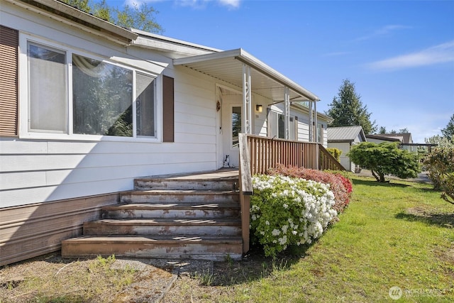 view of property exterior with a yard and covered porch