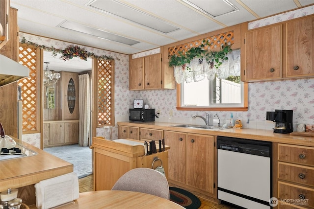 kitchen with dishwasher, wallpapered walls, black microwave, light countertops, and a sink