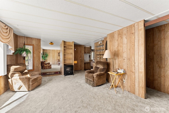 living room featuring wooden walls and carpet floors